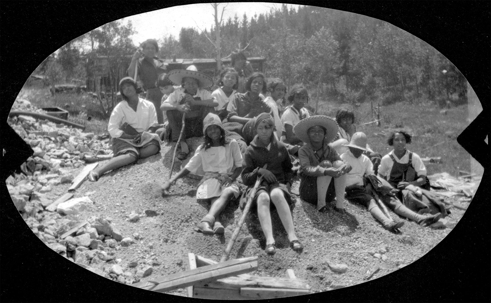 Group ready for a hike sitting on hill