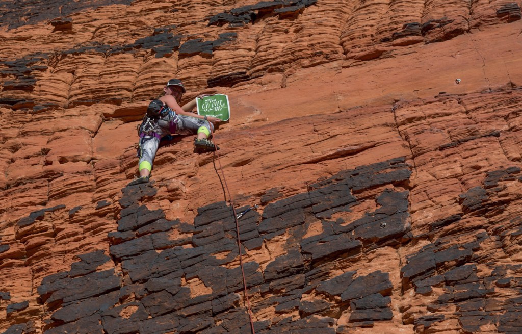 kristen evans scaling a rock wall while choosing to opt outside