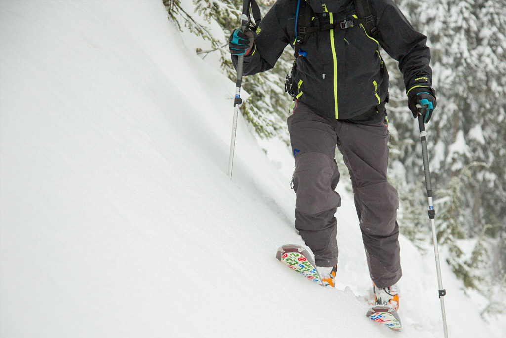 skier using poles on a steep slope