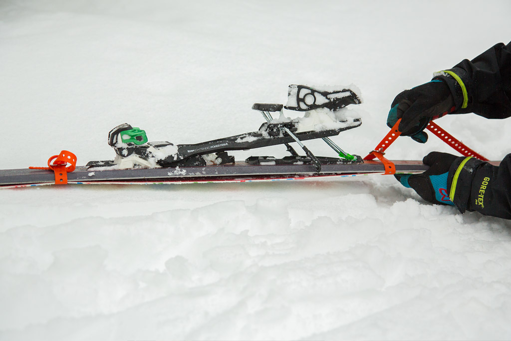 skier reinforces skins to ski with ski strap