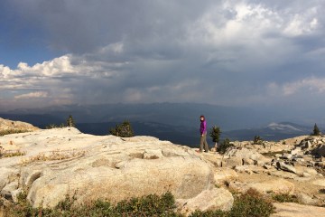 female standing at a mountain overlook