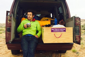 Brendan Leonard sits in his adventure vehicle with a cup of coffee.