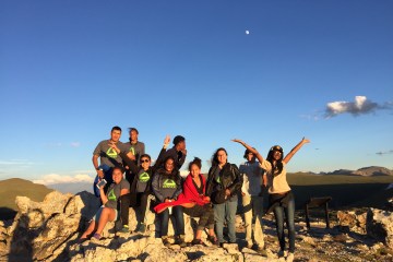 a group of outdoor stewards celebration on a mountain top