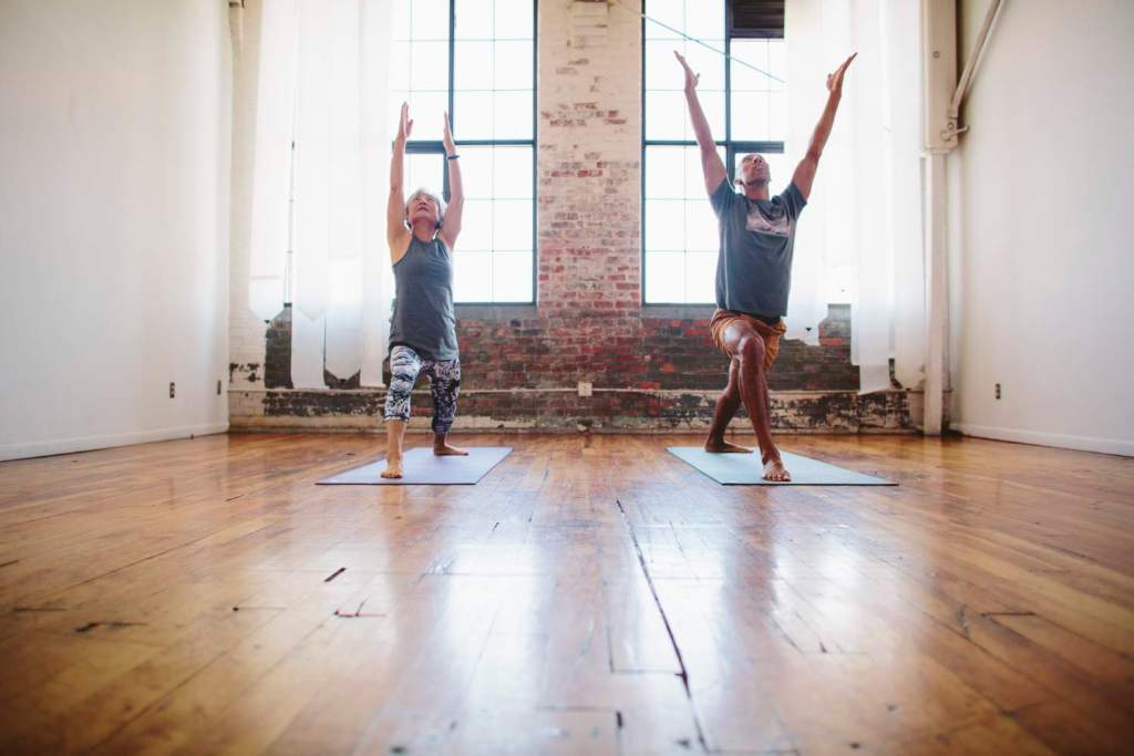 Two yogis in warrior