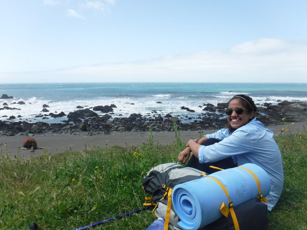 REI Adventures trip backpacker rests on the Lost Coast.