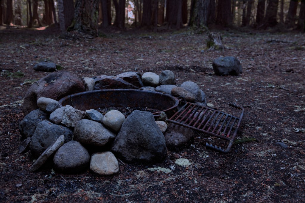 an unused fire ring as night falls