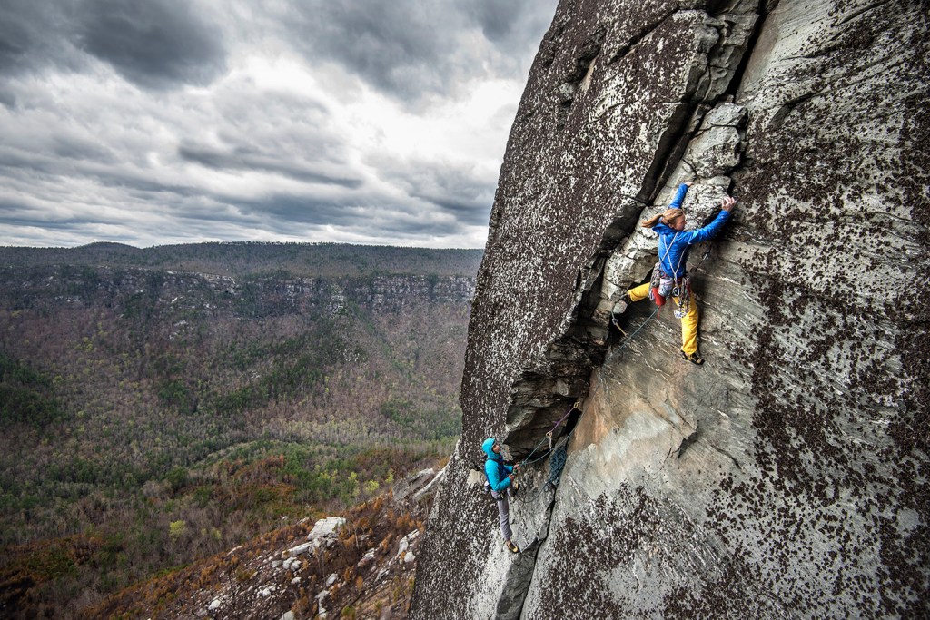 female climber leading at Linnville Gorge, NC.