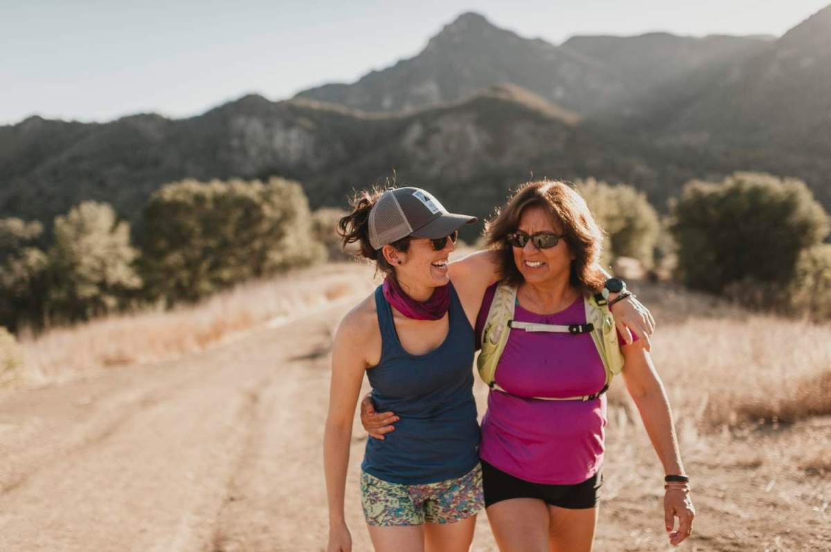 Mother and daughter hugging and walking