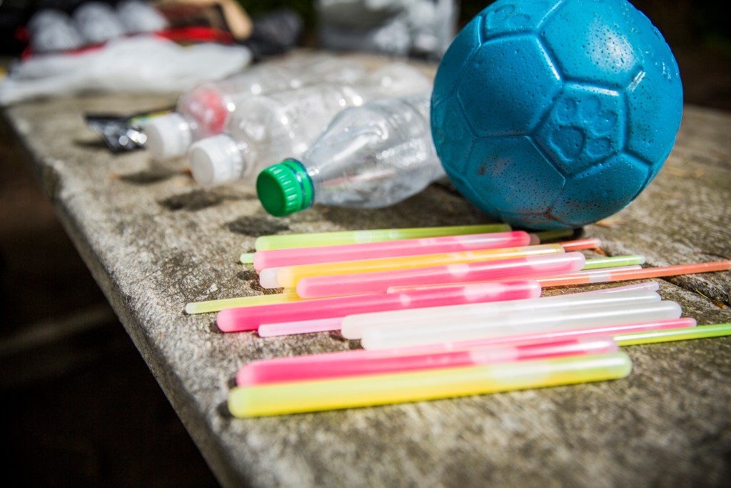 Glow sticks, soccer ball and water bottles