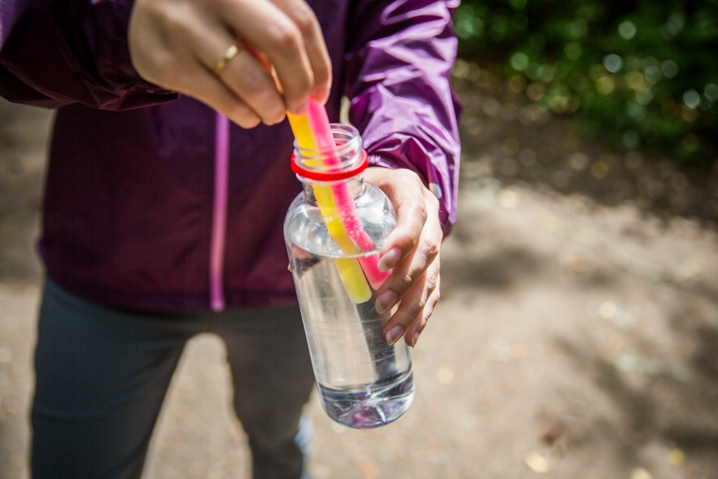 Putting glow sticks in filled plastic water bottle