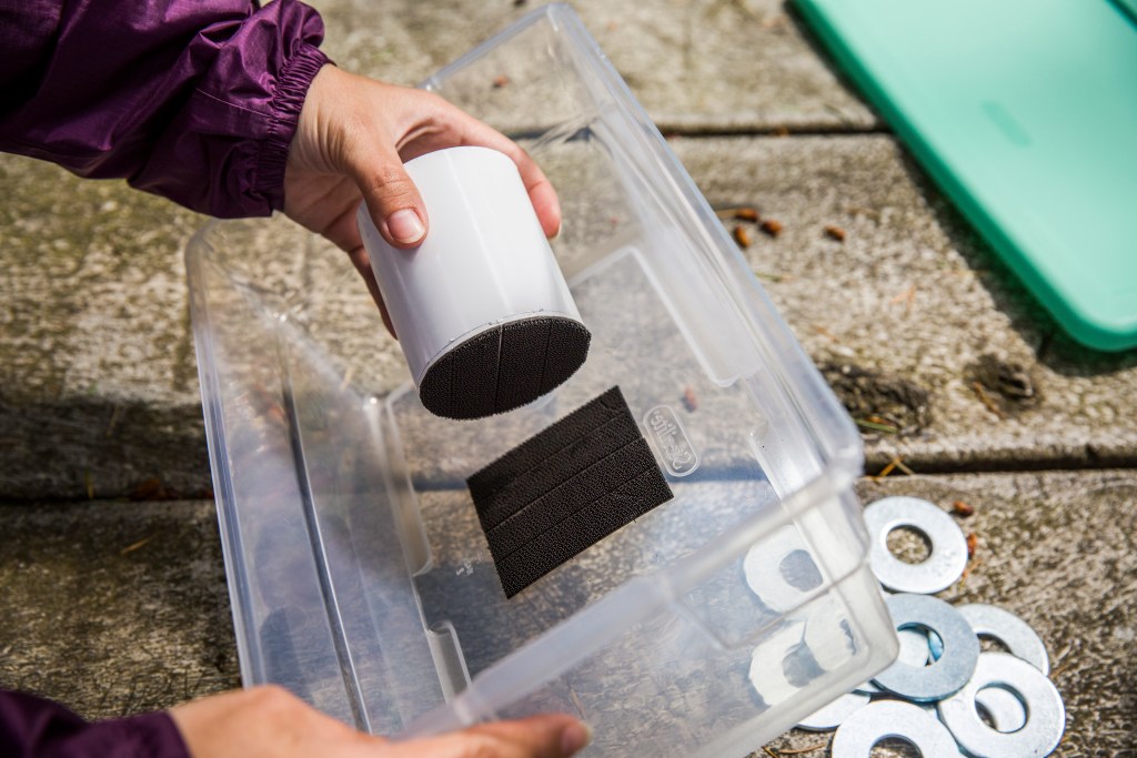 Attach the cup to the plastic bin