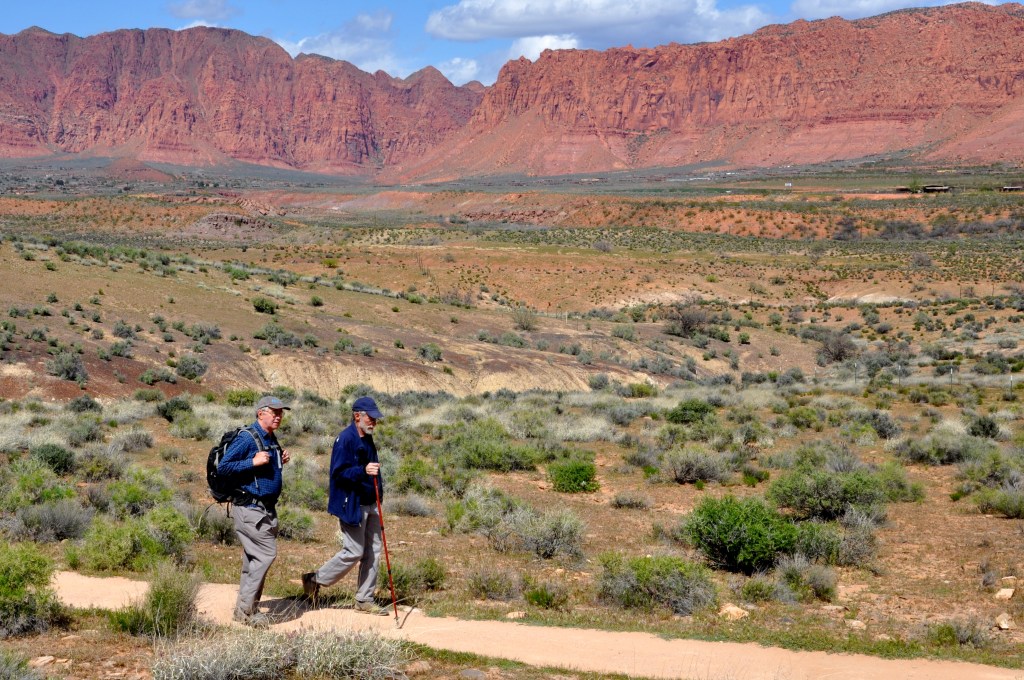 Hiking to see petroglyphs outside of St. George, Utah. Roberts (on the left) with Ed Ward 