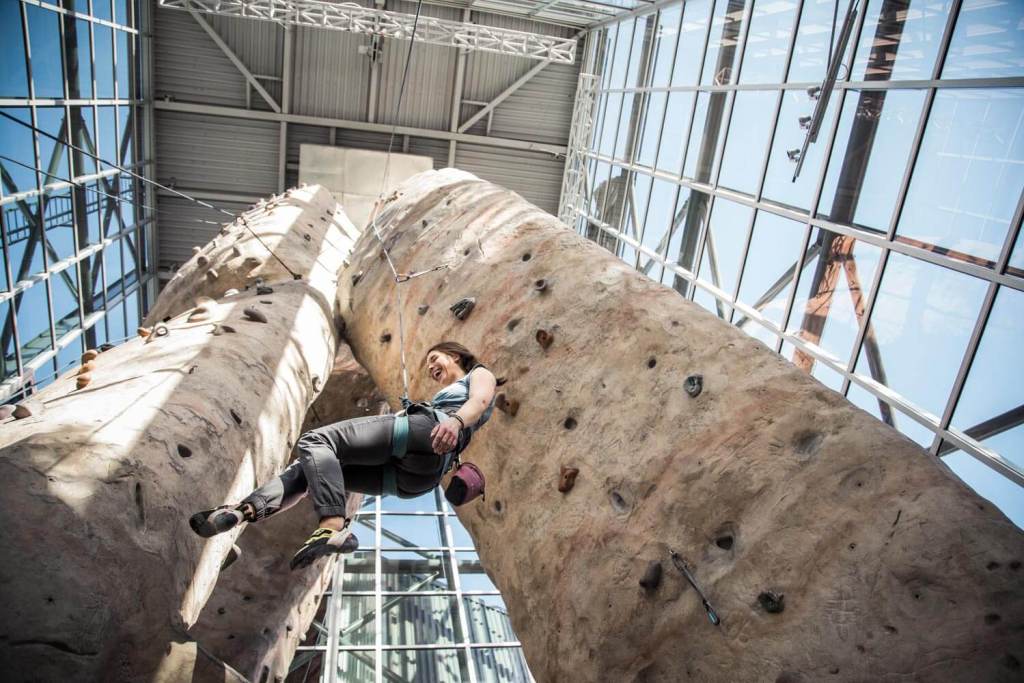 Woman smiling while climbing in the gym