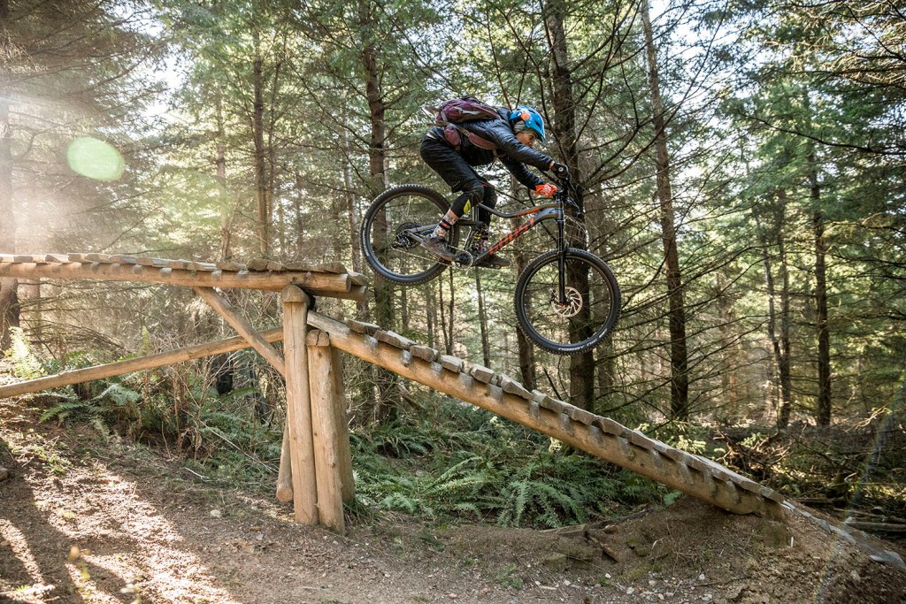 Mountain biker going down a ramp