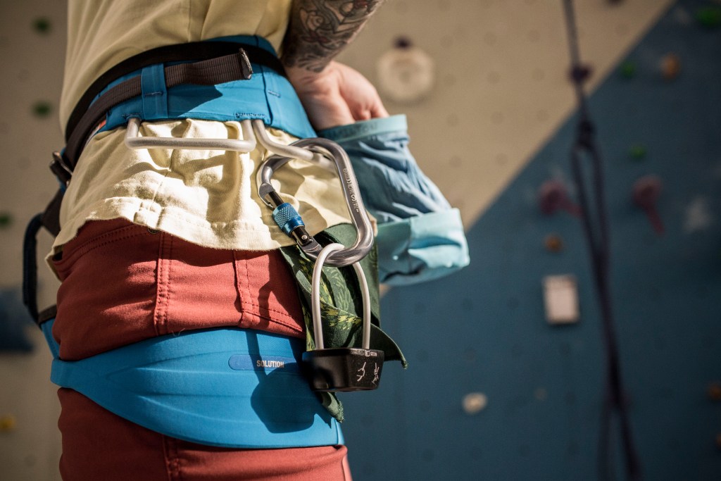 Person preparing to climb at a climbing gym