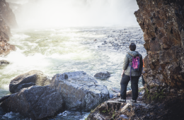 hiker looking at a waterfall