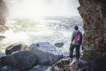 hiker looking at a waterfall