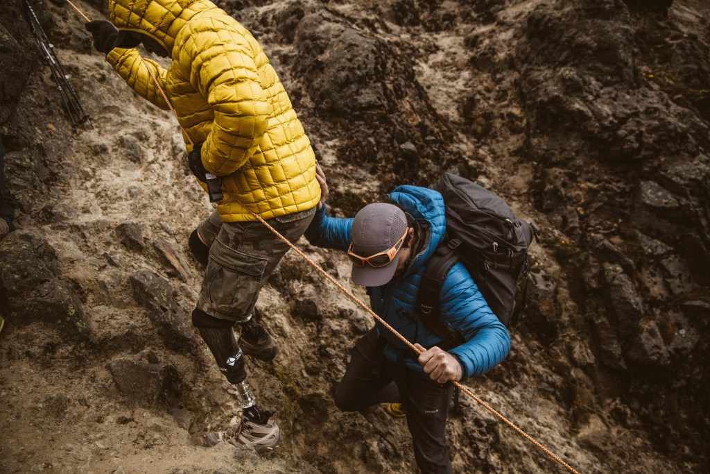 Reggie Showers rappels into a scree field