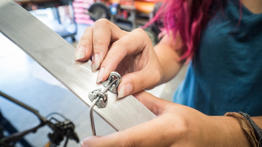 Mount the wire at the drilled holes using the cable clamps.