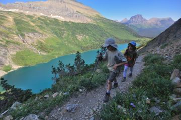 Nate and Alex hike along Gunsight Pass Trail in Glacier National Park