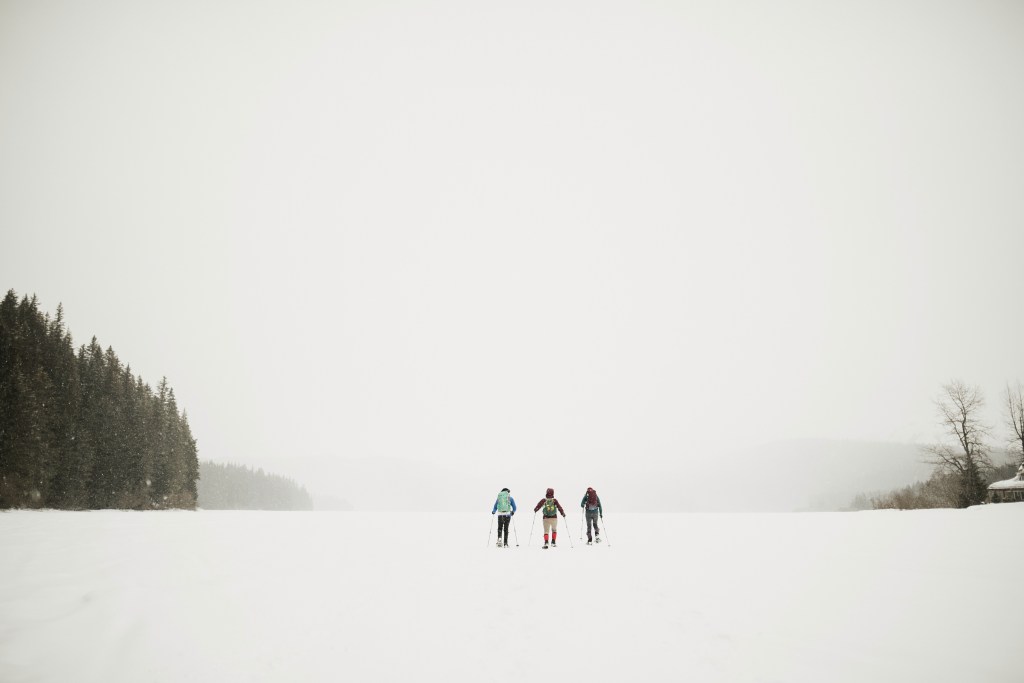 Three people walking in the snow