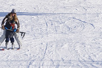 Anna and her son skiing