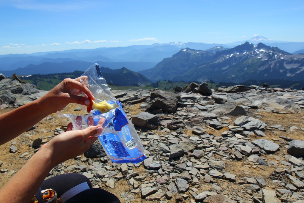 Hiker putting an apple core in a bag