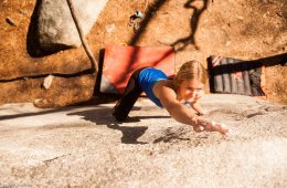 A climber on the Waves in Motion problem in Boat Rock.