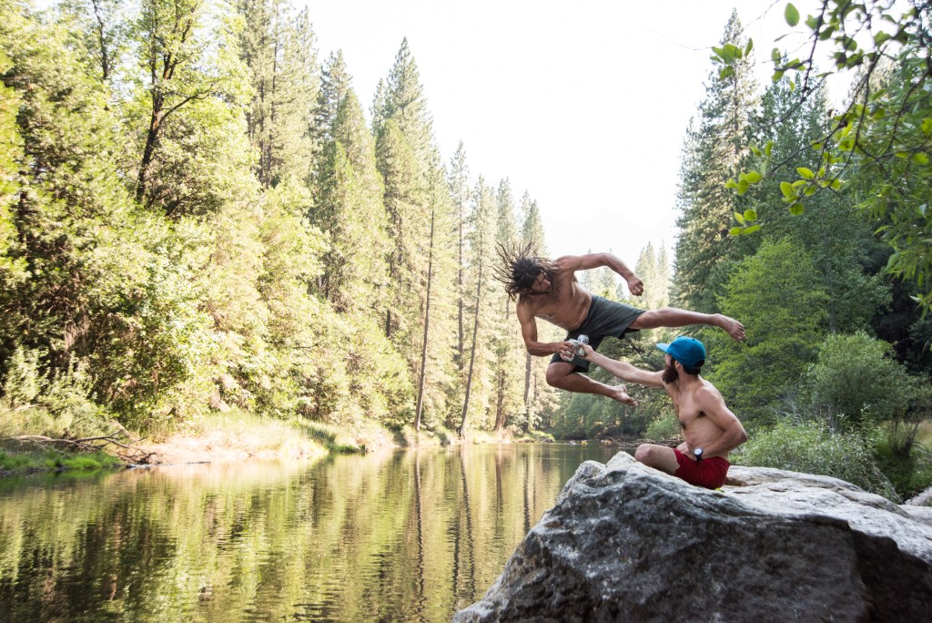 Ken Kries and Josh Huckaby cheers to summer while jumping into the river