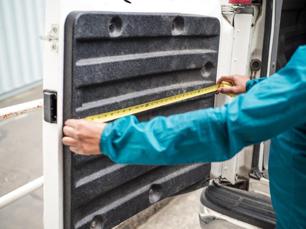 Person measuring van door dimensions 