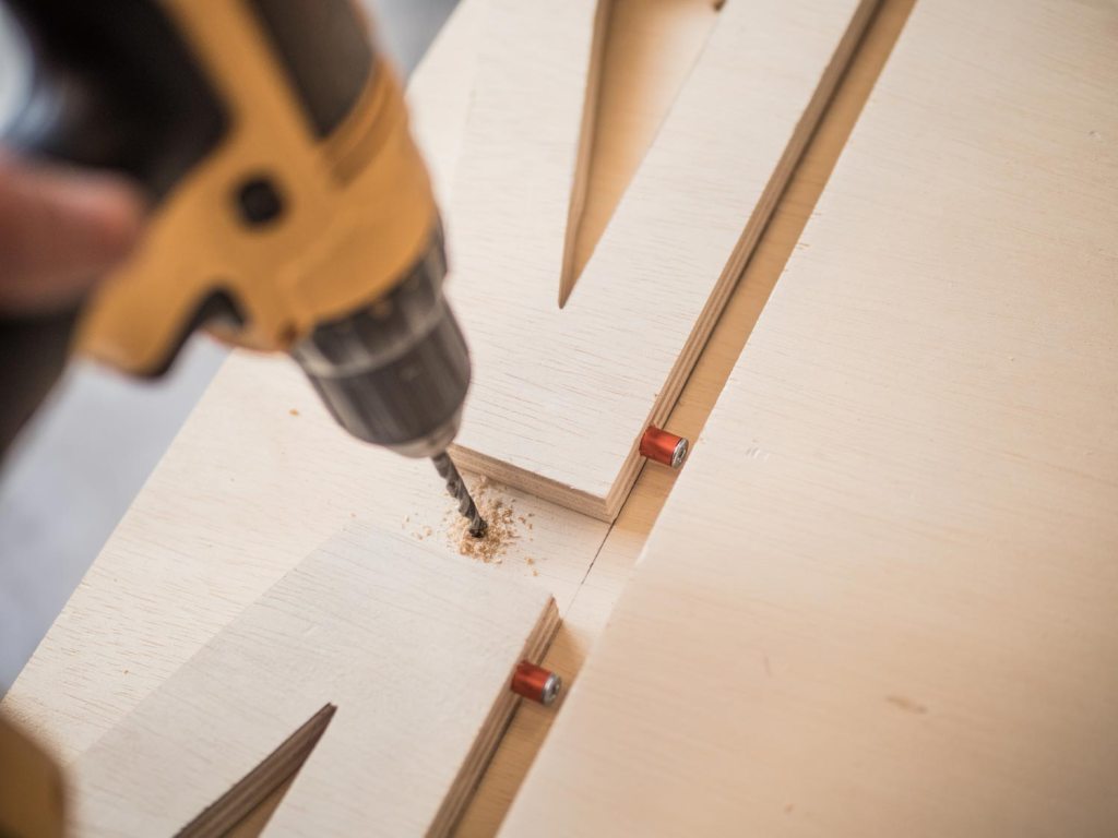 Drilling a hole directly between the folded-down supports