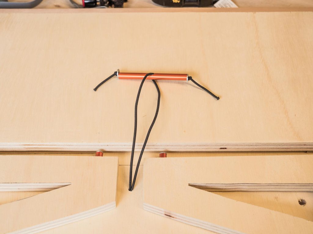 Elastic cord threaded through tent pole