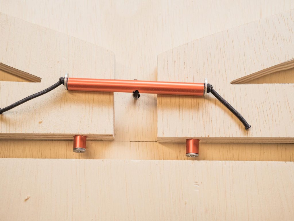 Tent pole sitting snugly against front of the supports