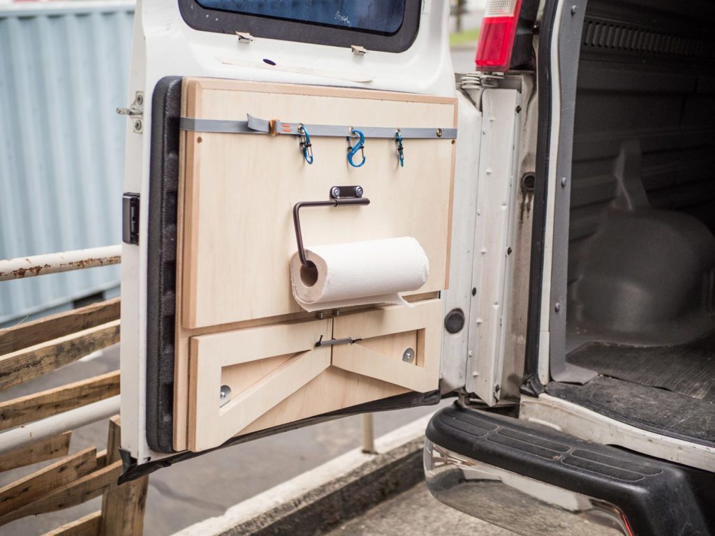 Adding a roll of paper towel to the van kitchen