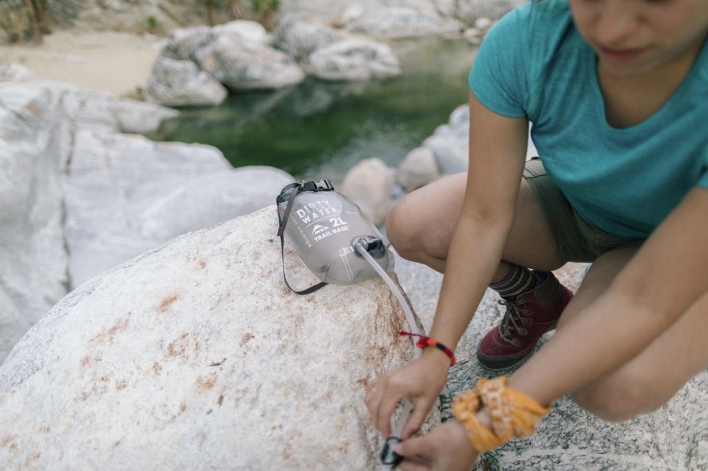 Hiker filtering water