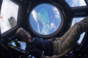 Shannon Walker, NASA astronaut, in the cockpit of a spaceship.