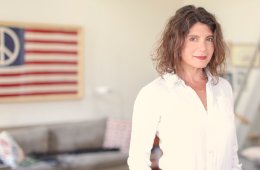 Elizabeth Weil standing in front of her desk, smiling at the camera.