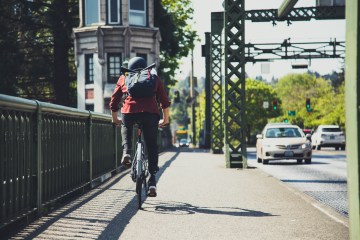 bike commuter on a bridge