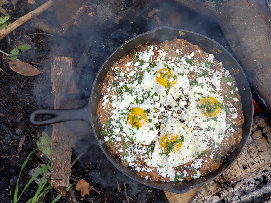 A cast iron pan with freshly cooked chilaquiles.