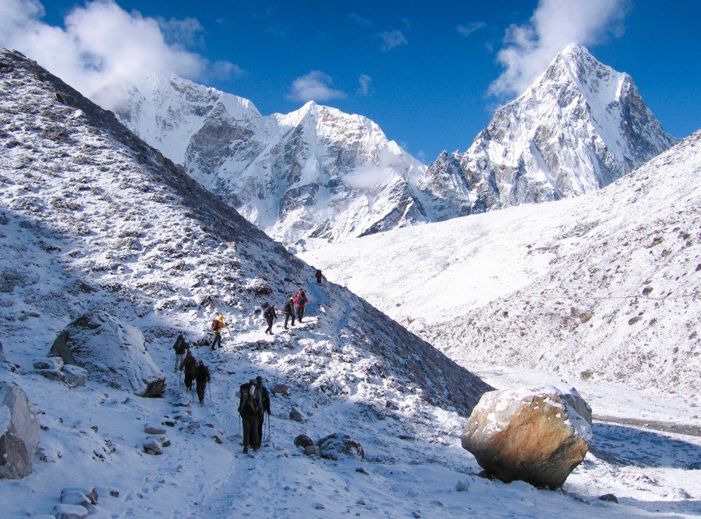 A group of hikers with an REI Adventures trekking tour navigate the Himalayan high country.