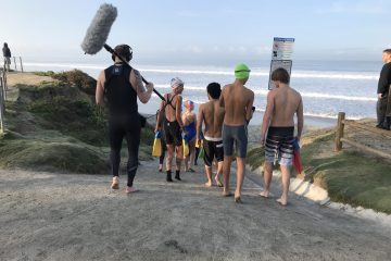 Students from Sea Change Preparatory school heading to the ocean to swim.