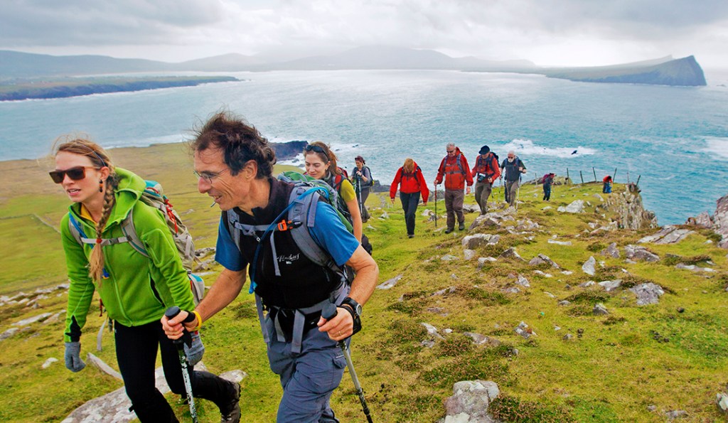 A group of hikers trek along the Irish coast.