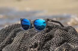 Black sunglasses sit on a fishing net.