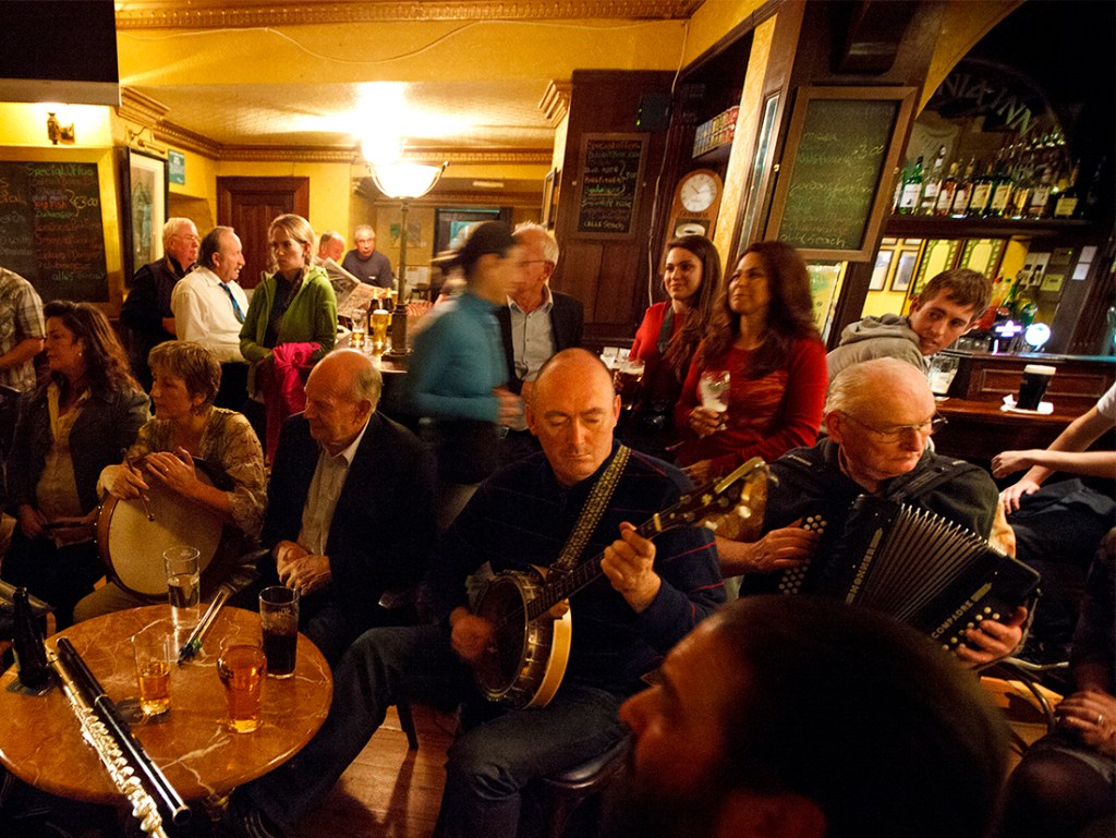 An Irish band plays for a pub full of patrons.