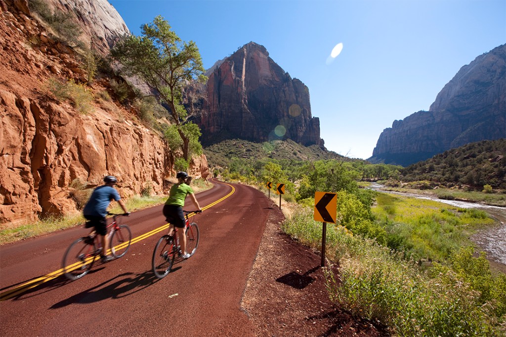 Cyclists pedal through the interior of Zion National Park.