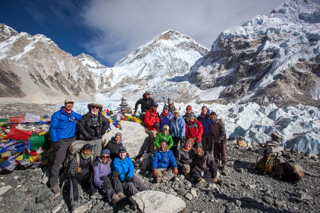 A group of hikers poses at Everest Base Camp.