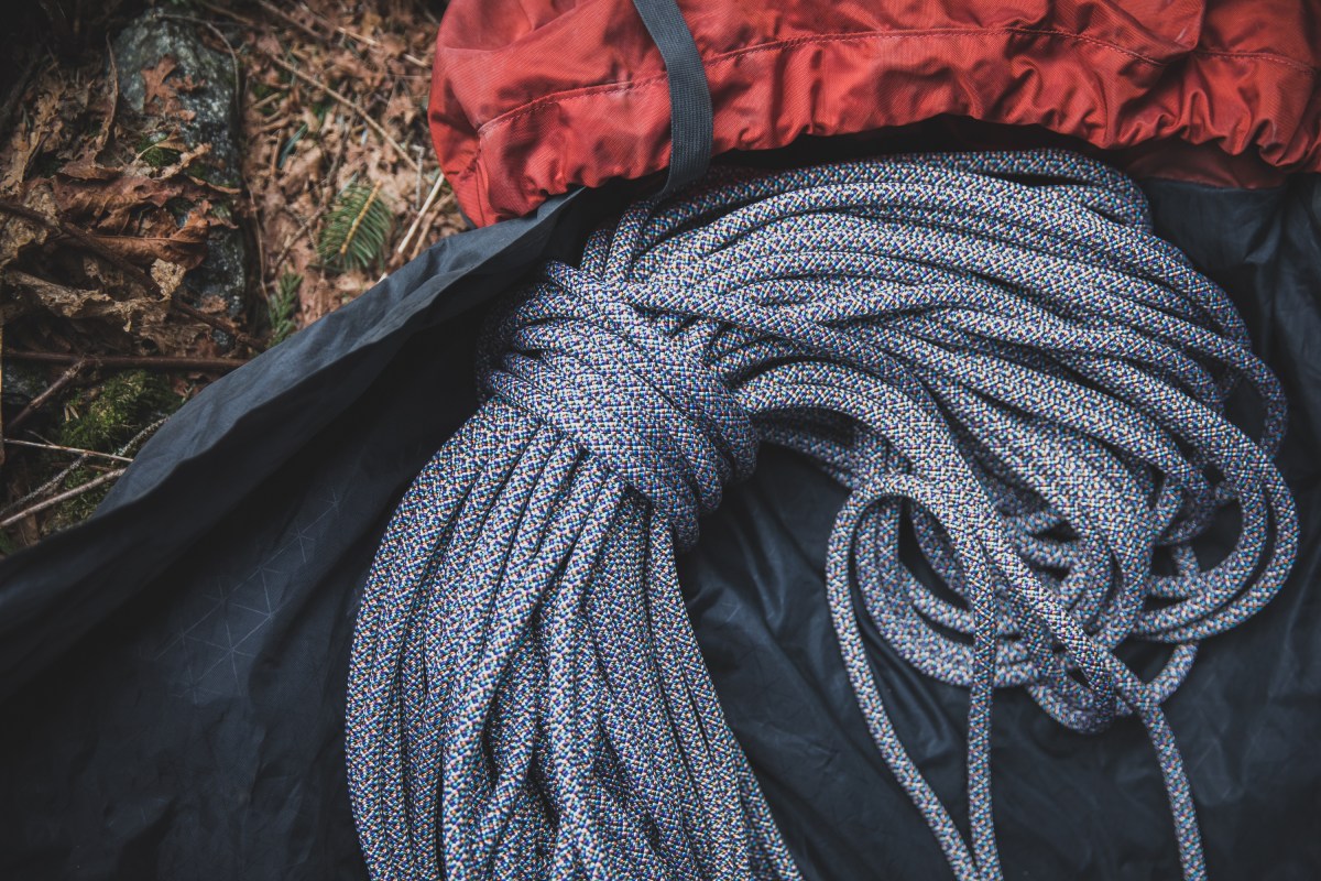 Climbing rope in rope bag sits on the ground.