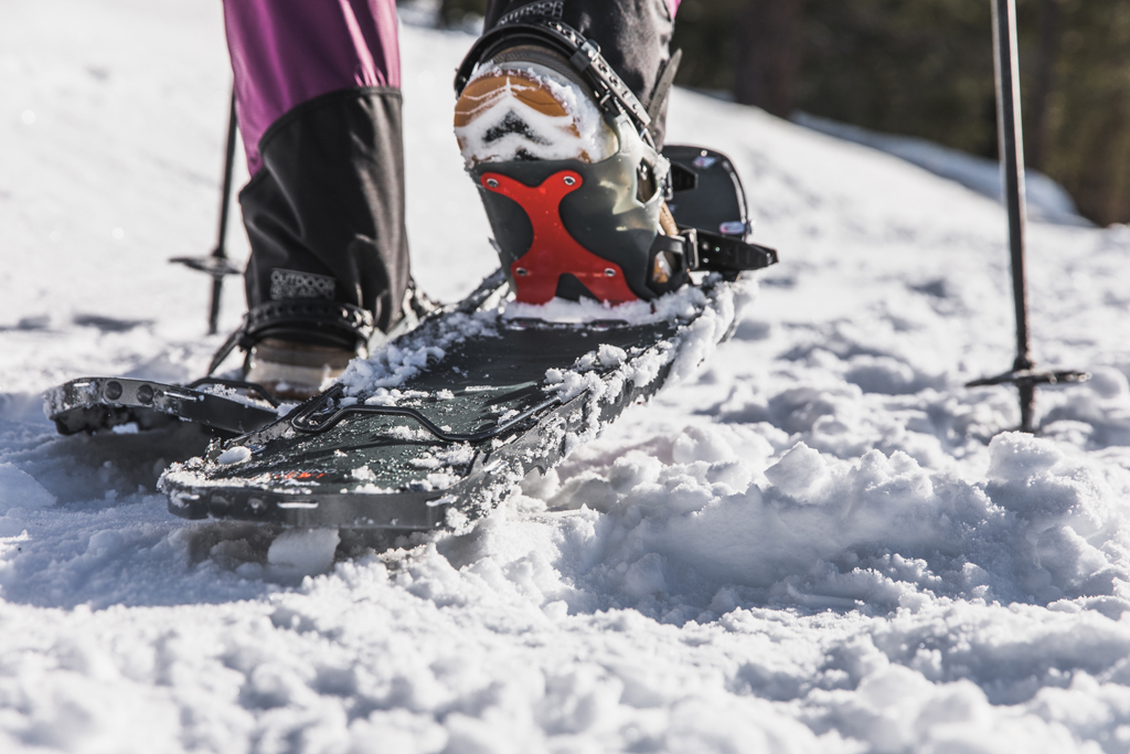 The back of a woman's foot as she's walking in the MSR Lightning Ascent snowshoes