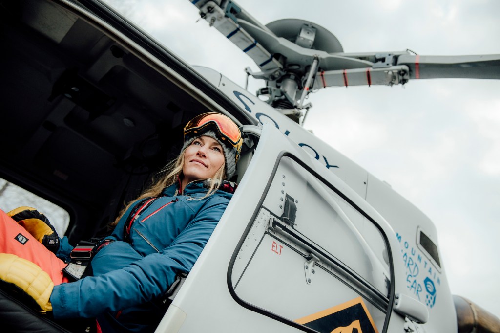 Pro skier Elyse Saugstad sits in a helicopter in Alaska.