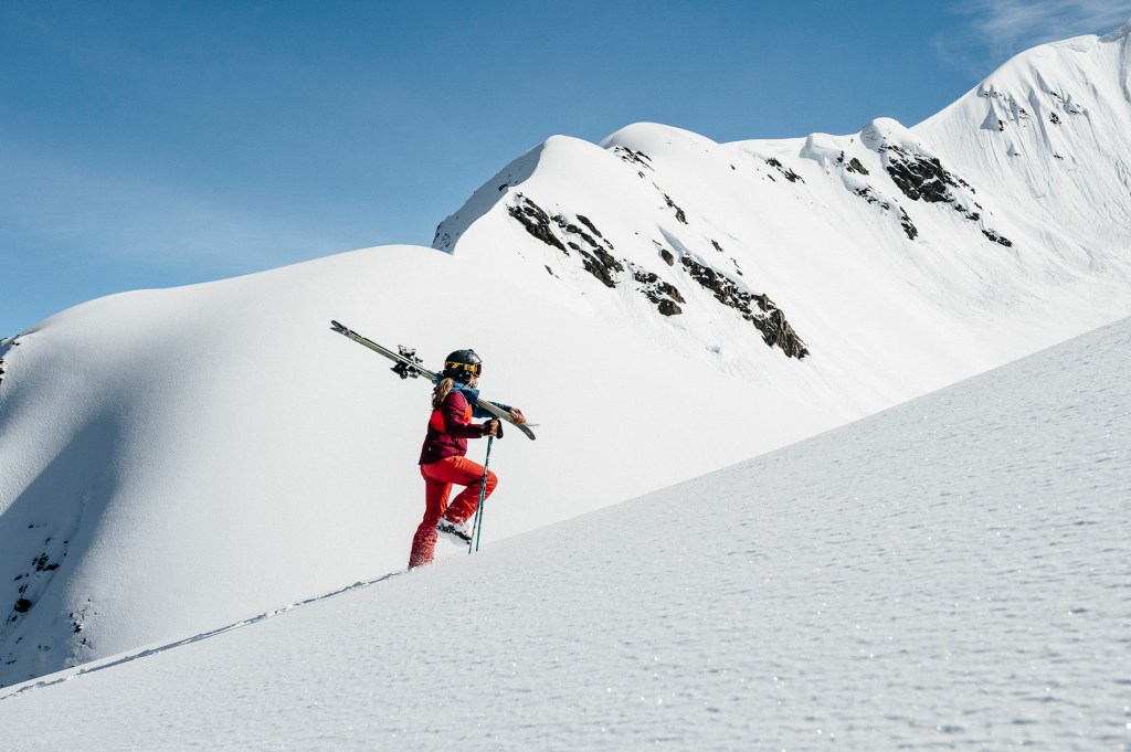 Elyse Saugstad bootpacks up a mountain in Alaska.